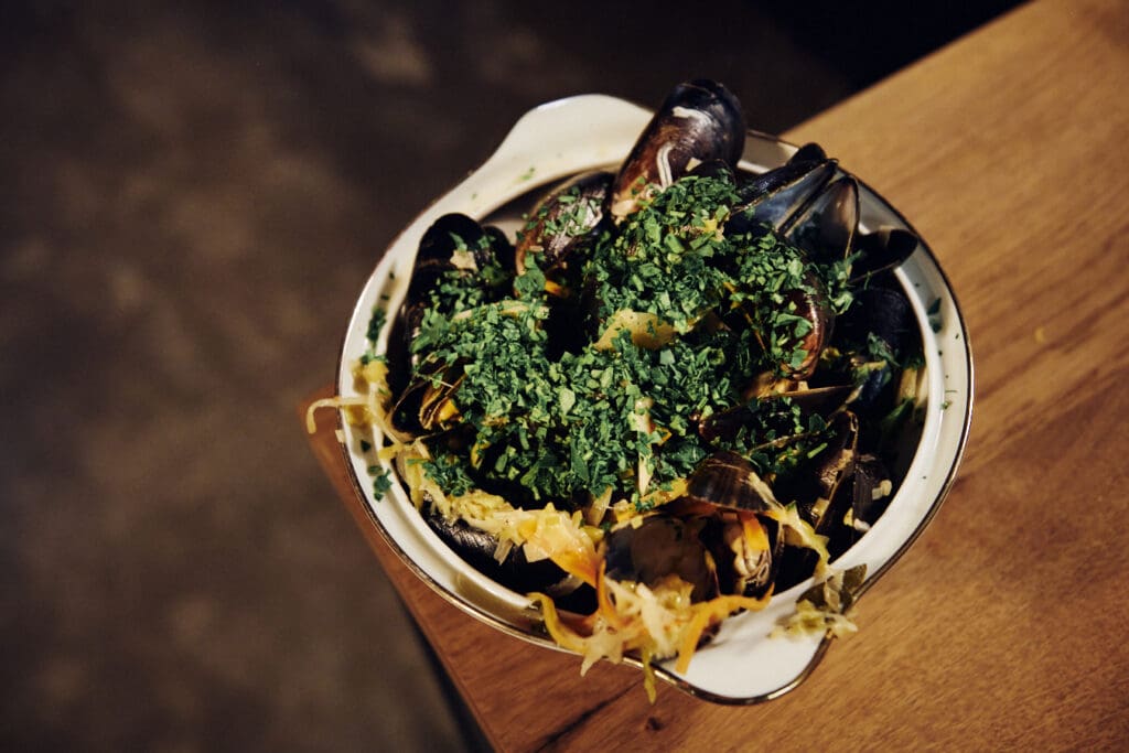 Schüssel mit Muscheln und frischen Kräutern